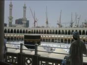 The view of the Kaaba at the Masjid Al Haram in Makkah Saudia Arabia just after the mid day prayers. A pilgrim stands back and is in deep prayer and thought as he looks towards the Kaa'ba. It is advised for visitors to always book flights and hotels in advance in order to get the best rate before prices go sky high