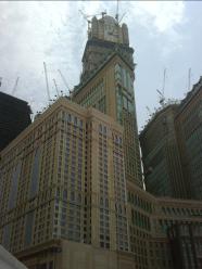 The view from ground level of the brand new huge Clock Tower opposite the Masjid Al Haraam in Makkah, Saudi Arabia where you should book International Airline Reservations for the best deals